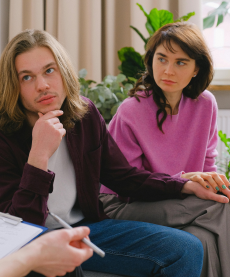 Couple sitting and listening to the therapist in a couples therapy session Couple sitting and listening to the therapist in a couples therapy session