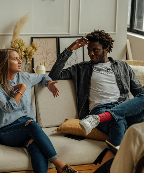 Couple talking to each other while in the middle of a couples therapy session