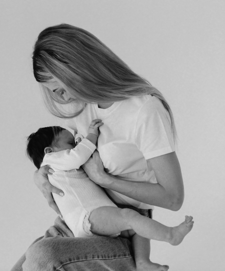 Black and white photo of mother feeding baby